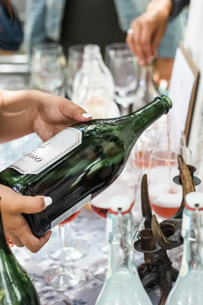 Sparkling wine poured at a drinks table